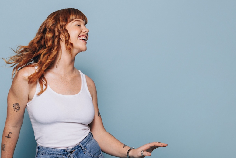 Woman with ginger hair dancing and having fun in a studio