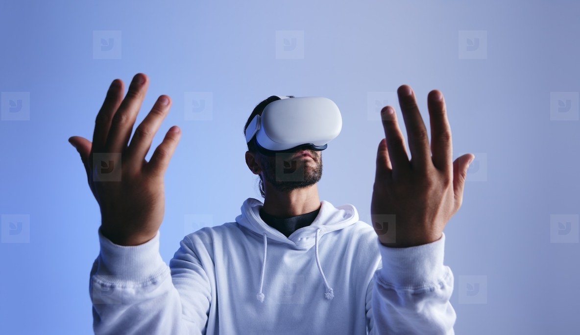 Man wearing virtual reality goggles in a studio
