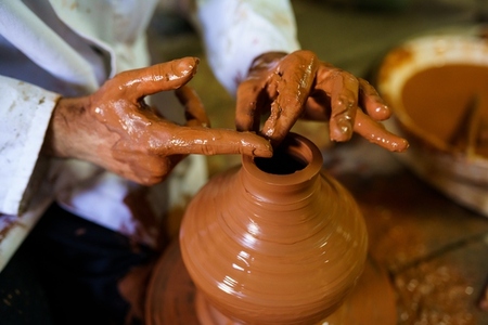 Craftsman moulding a piece of pottery on an Arab potters wheel
