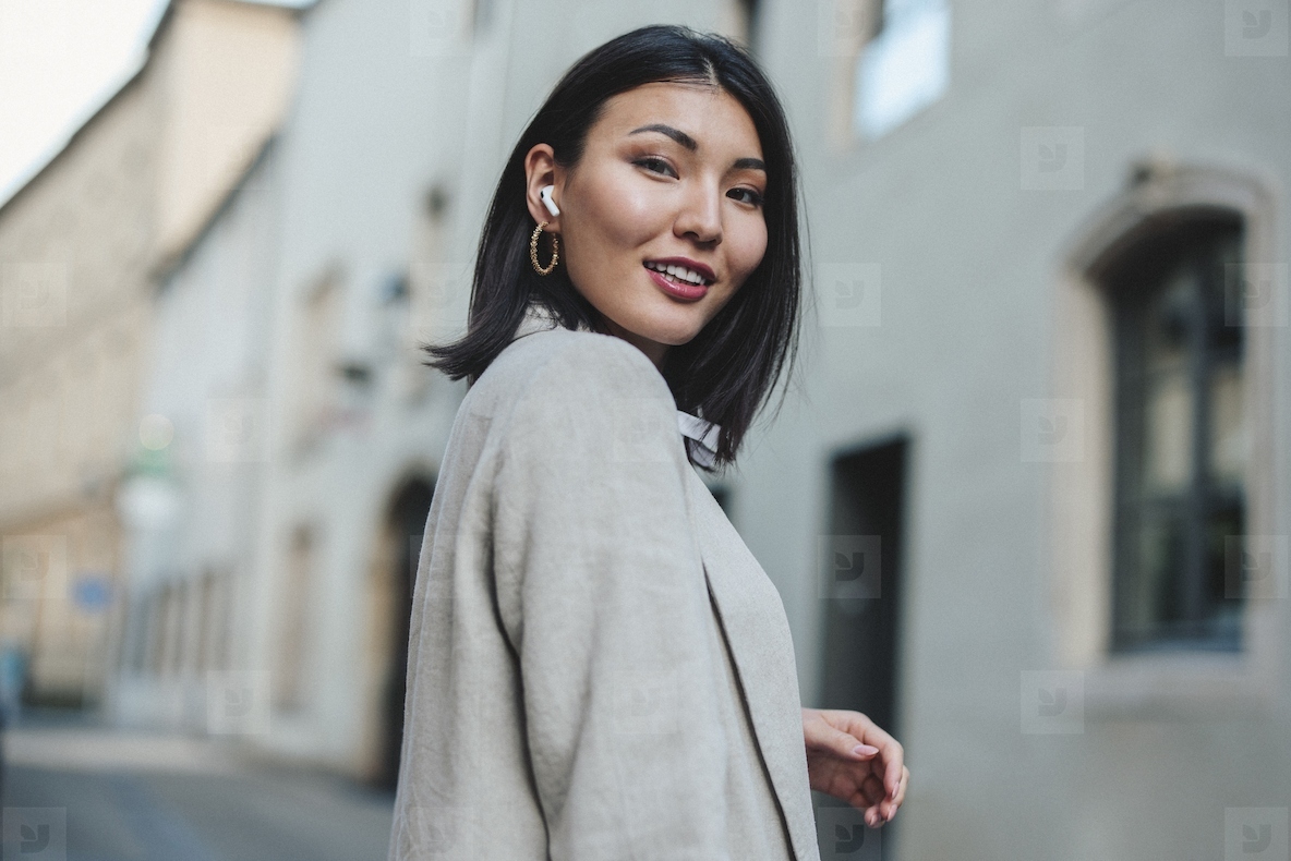 Woman with earphones walking in the city
