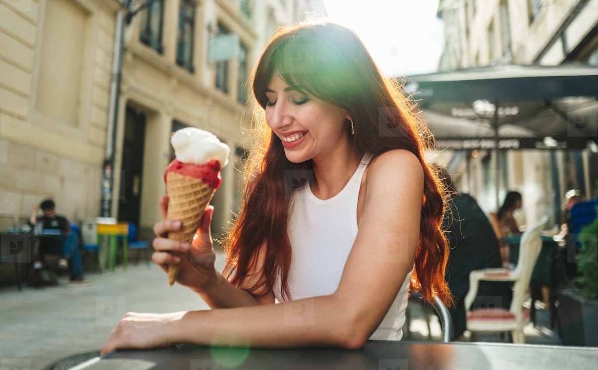 Tourist eating an ice cream at an outdoor restaurant