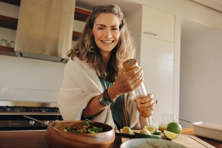 Vegetarian woman preparing a wholeseome plant based meal at home
