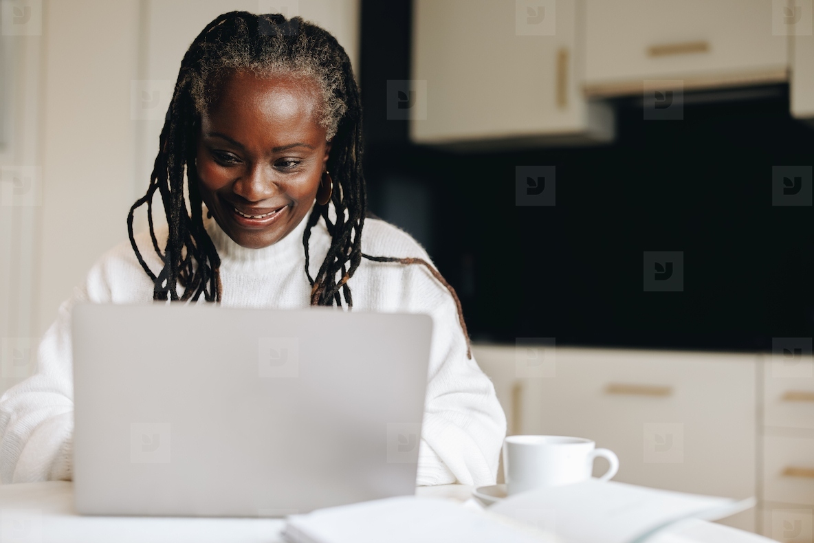 Mature businesswoman working on a laptop at home