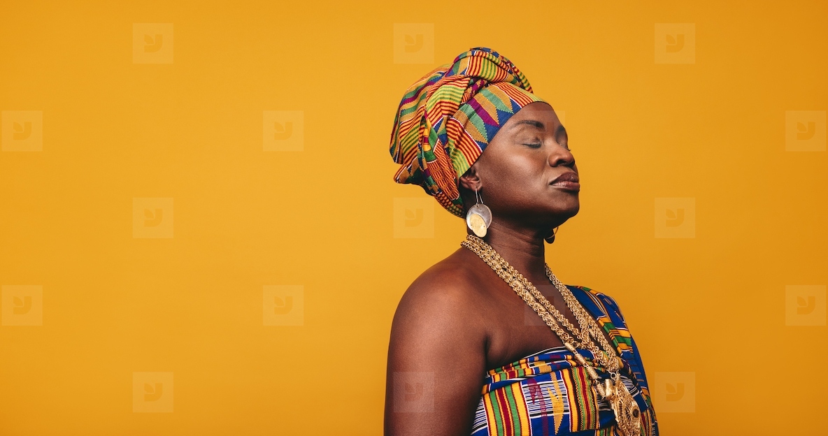 African woman wearing traditional clothing in a studio