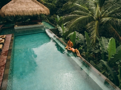 Couple relaxing at the poolside of resort