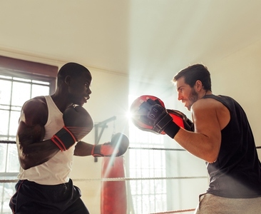 African boxer training with a sparring partner in a gym