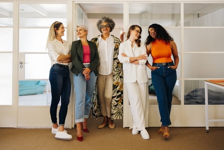 Group of successful businesswomen smiling happily in an office