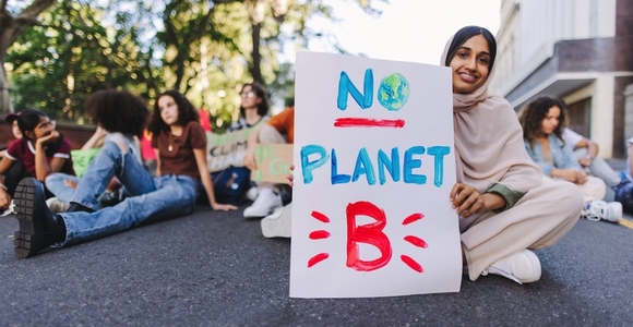 Happy Muslim girl protesting against climate change