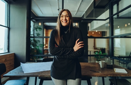 Female business professional smiling happily in an office