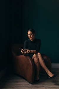 Asian woman using a smartphone in an office