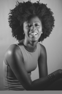 Black and white photograph of cheerful black model looking at camera