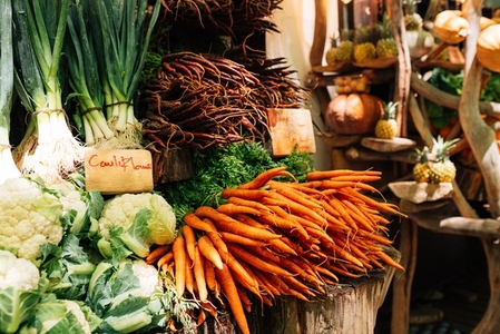 A lot of vegetables on a stall on an outdoor market