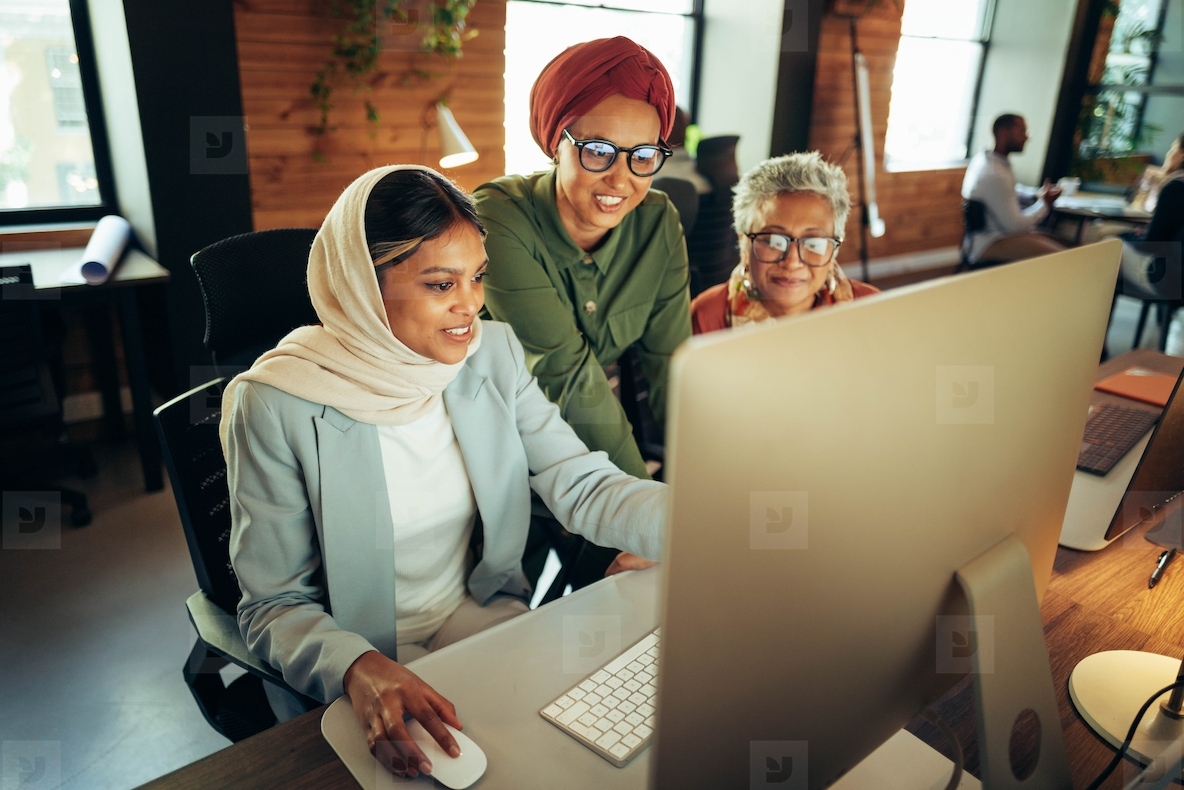 Three businessswomen working together in a coworking office