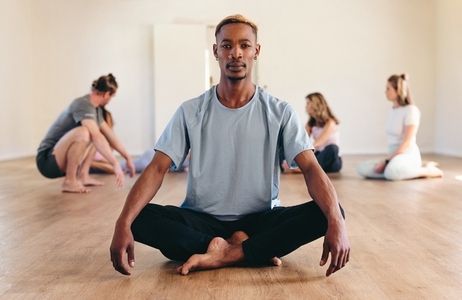 Portrait of a male yogi sitting in lotus position