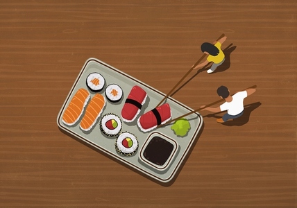 Couple with chopsticks eating large tray of sushi