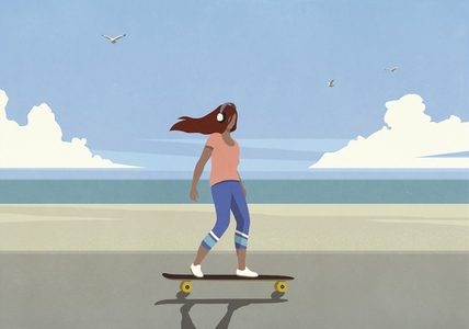 Carefree young woman skateboarding on summer beach boardwalk