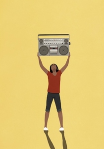 Carefree woman holding boom box overhead on yellow background