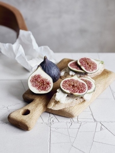 Still life fresh cut figs on cutting board