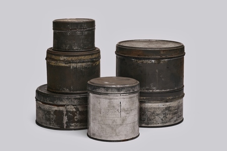 Old paint tins on white background
