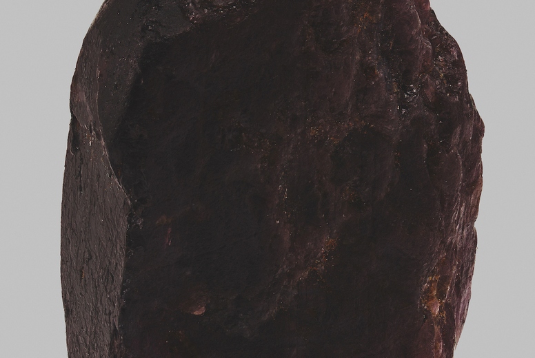 Close up still life dark red Thai sapphire on gray background