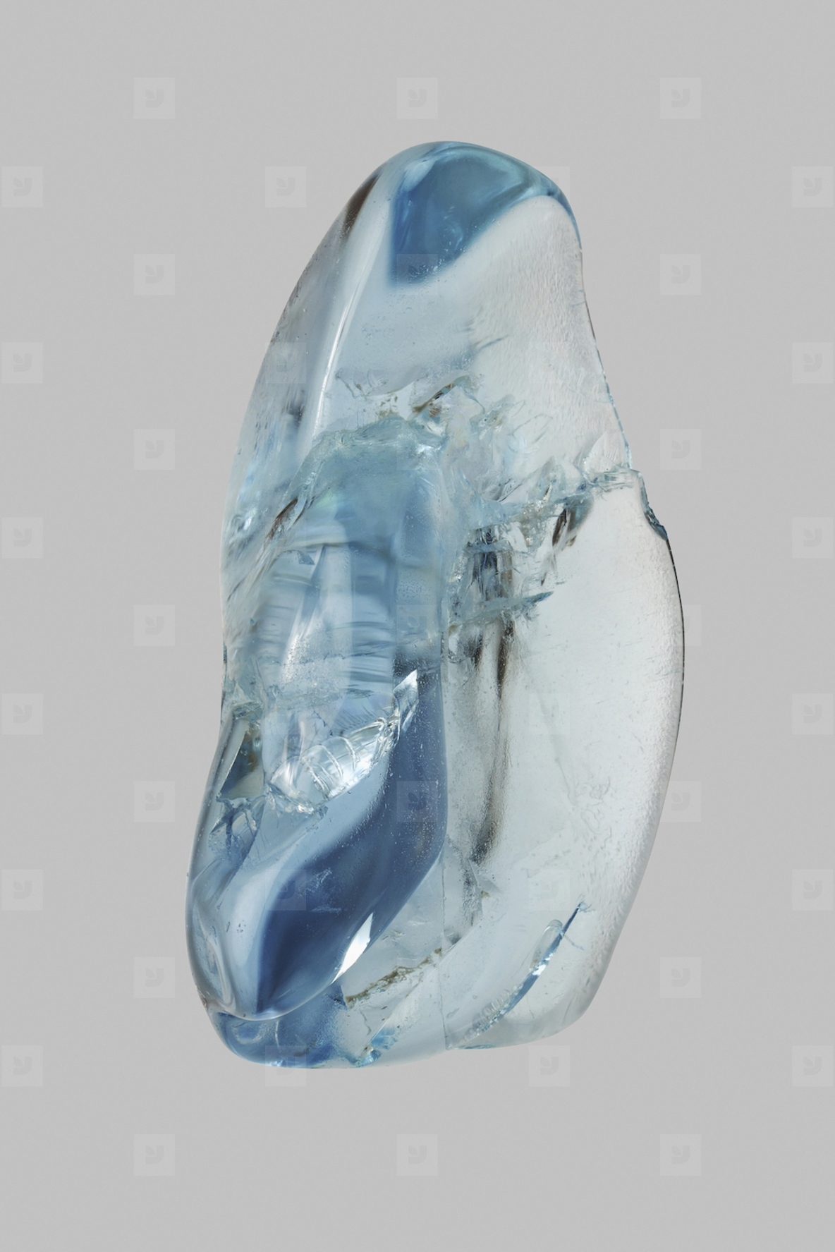 Still life close up blue aquamarine stone on gray background