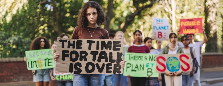 Young girl leading a march against climate change