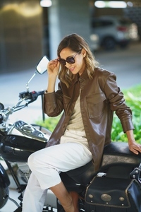Female biker sitting on motorcycle