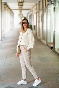 Stylish woman in sunglasses with hand in pocket