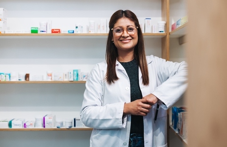 Female pharmacist standing in a drug store
