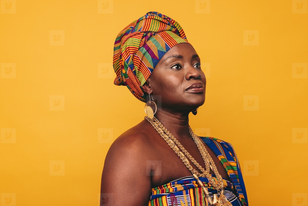 Mature African woman wearing traditional clothing in a studio