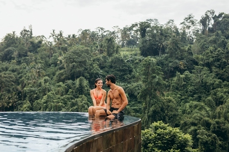 Young couple in swimming pool enjoying holiday