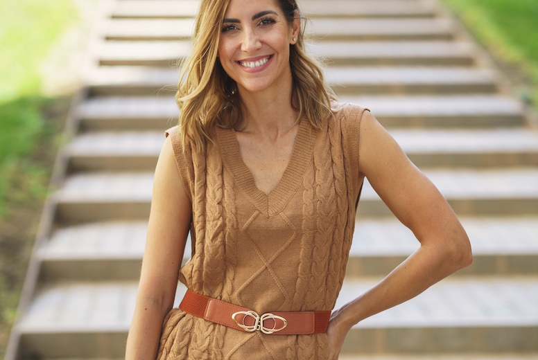 Cheerful stylish woman standing near steps