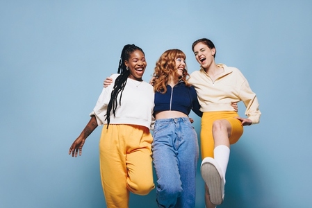 Group of cheerful female friends having fun together in a studio