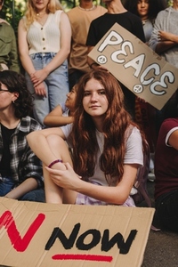 Young girl sitting with a group of youth peace activists