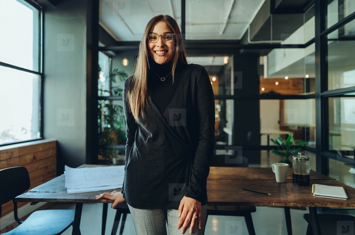 Successful businesswoman smiling happily in an office