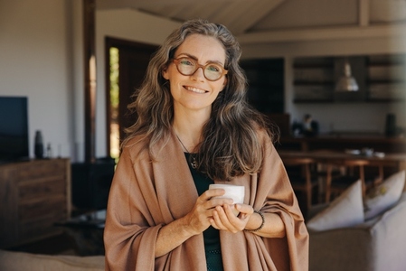 Portrait of a happy senior woman holding a cup of tea