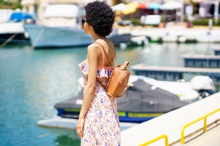 Black woman admiring sea in port