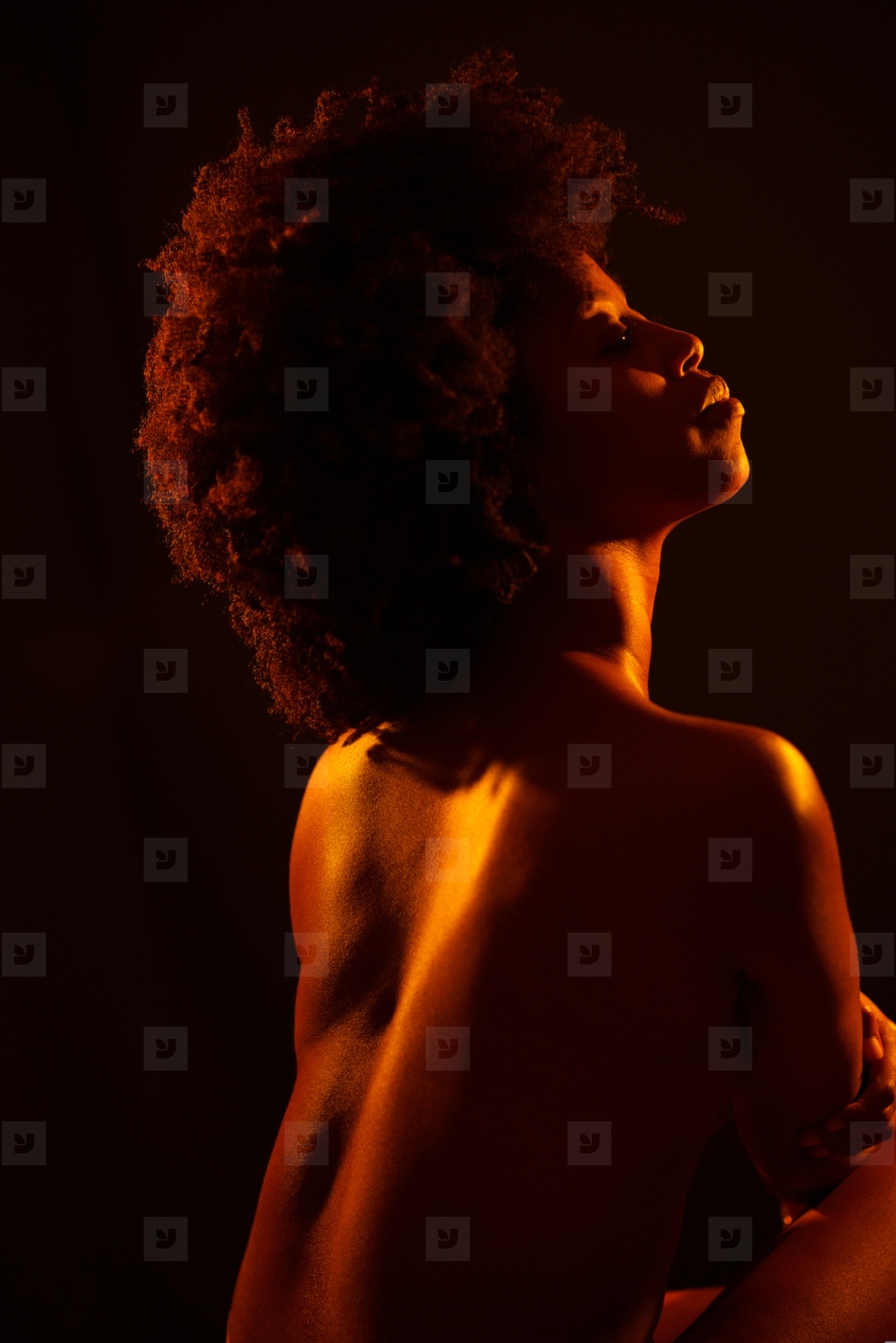 Calm black woman embracing naked torso