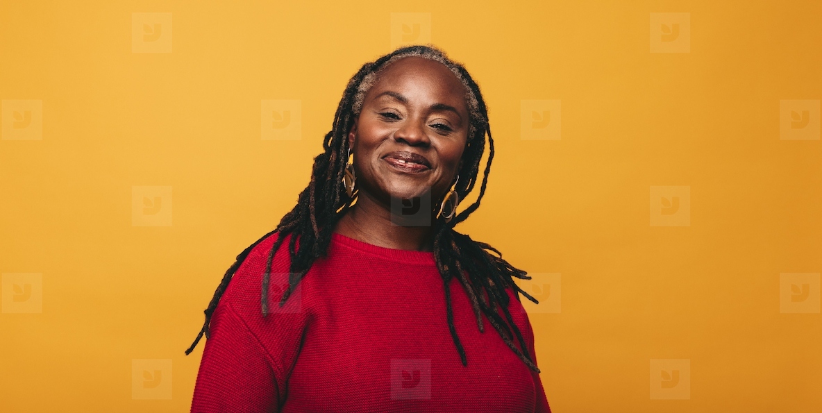 Portrait of a woman with dreadlocks smiling at the camera