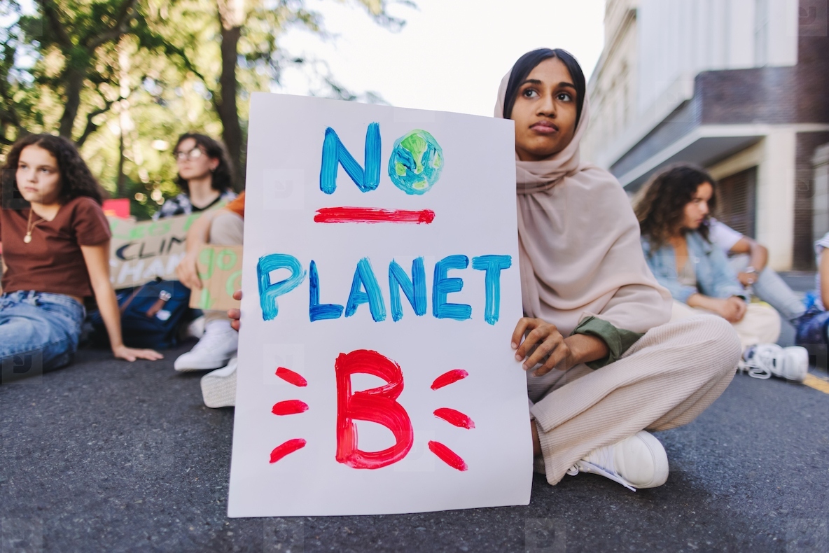 Young Muslim girl protesting against global warming