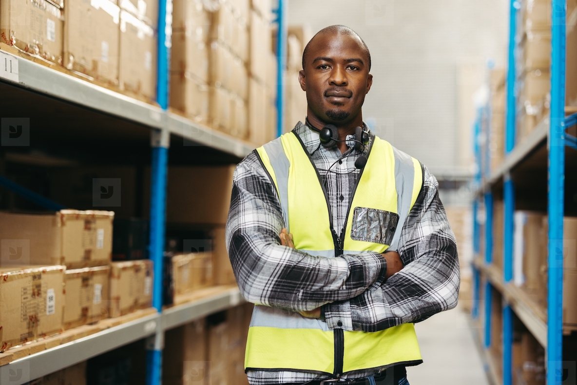 Male warehouse picker looking at the camera
