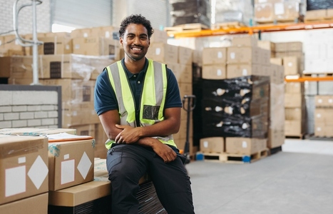 Cheerful logistics worker smiling at the camera