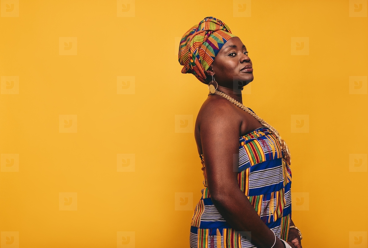 Stylish African woman wearing traditional clothing in a studio