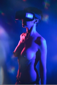 Sensual naked lady exploring cyberspace in VR headset