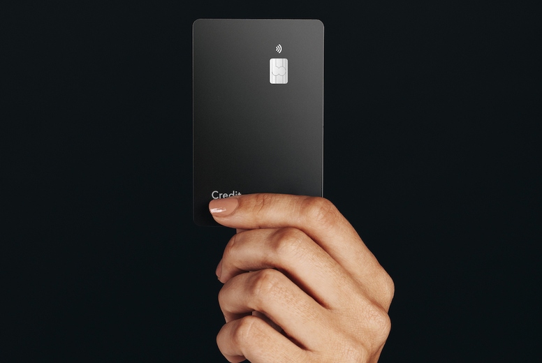 Premium banking with a contactless card Hand holding a black credit card in a studio