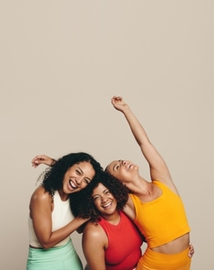 Celebrating sport and fitness Three young women standing in a studio wearing fitness clothing