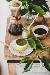 Green matcha cheesecake for dessert and brewed coffee in flask