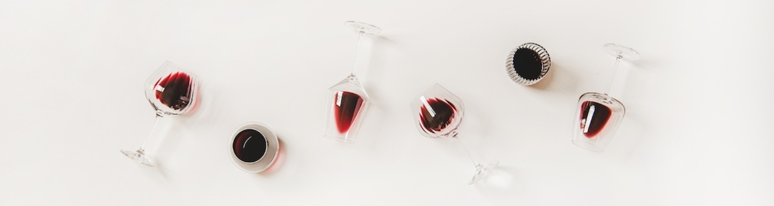 Wine glasses with red wine in row  wide composition