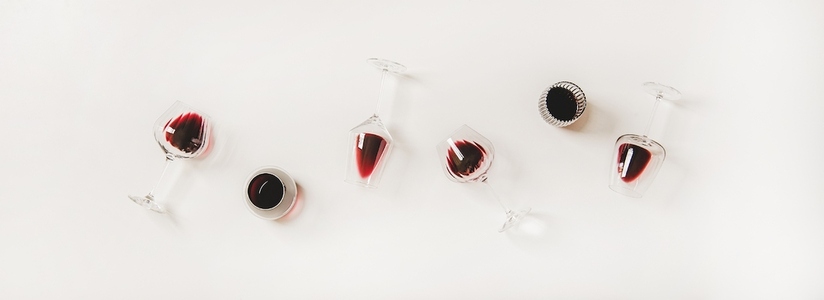 Flat lay of wine glasses with red wine in row