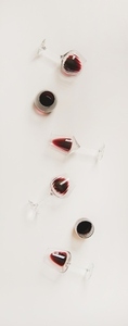 Wine glasses with red wine in row  vertical composition